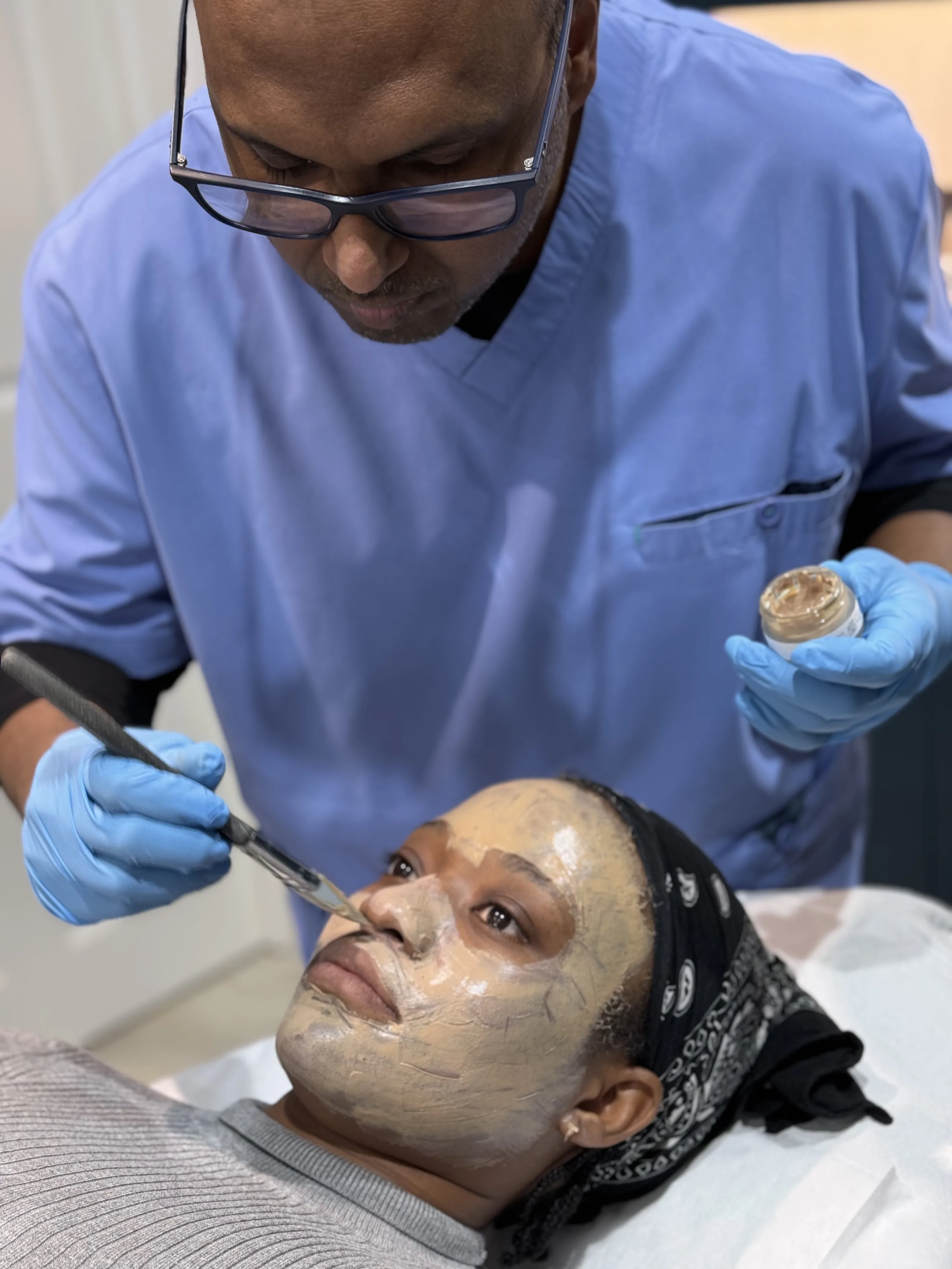 Dr Nick applying a chemical peel to a patient's face during a doctor-led treatment at Rejuvena Clinic, Bedford