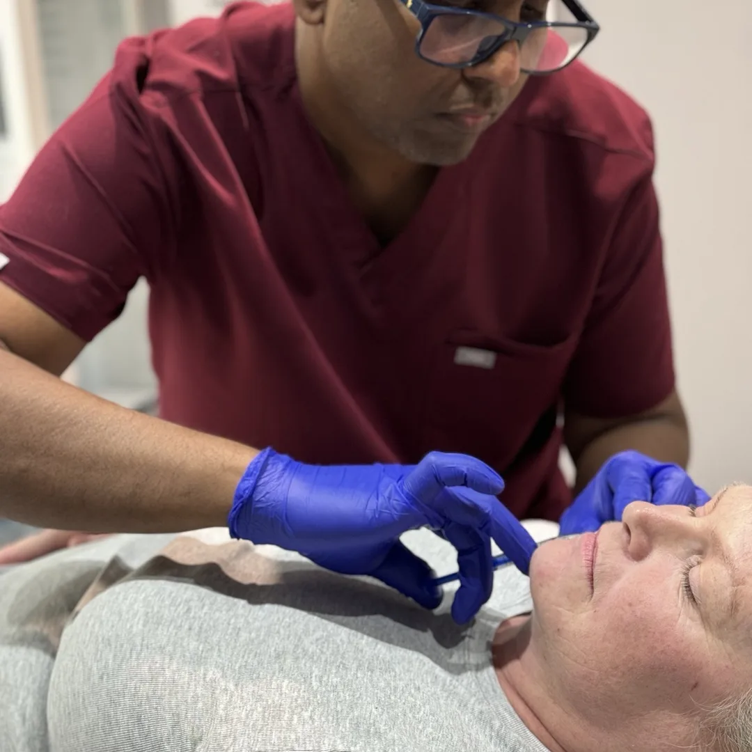 Dr Nick performing a doctor-led fat dissolving injection under a patient's chin at Rejuvena Clinic, Bedford