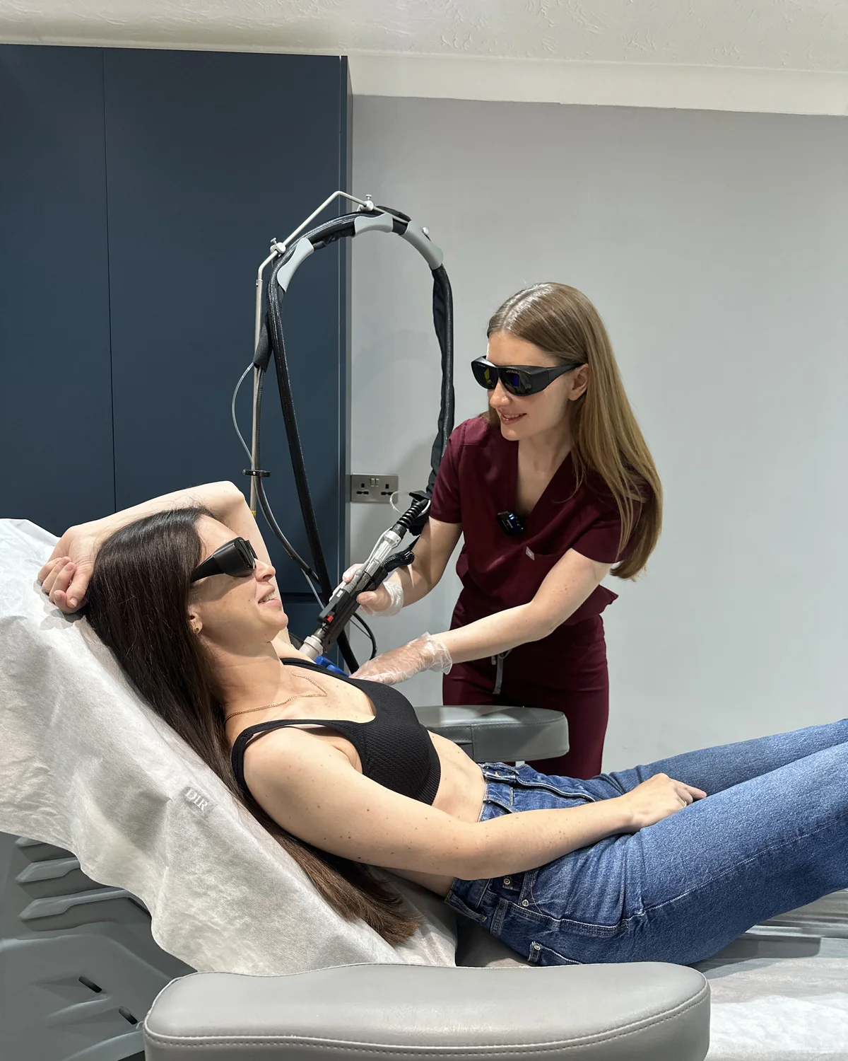 Skin therapist Lana performing laser hair removal on a patient's underarm at Rejuvena Clinic, Bedford