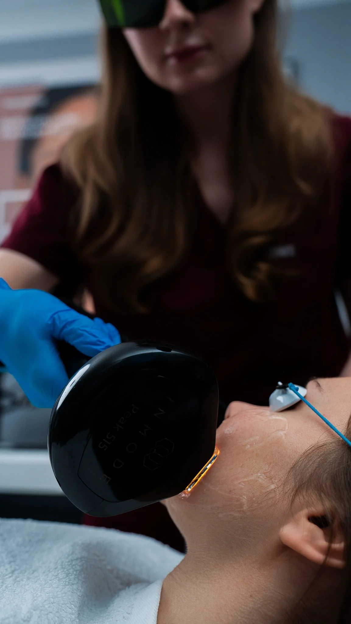 Clinician performing Lumecca® IPL on a patient's face at Rejuvena Clinic, Bedford