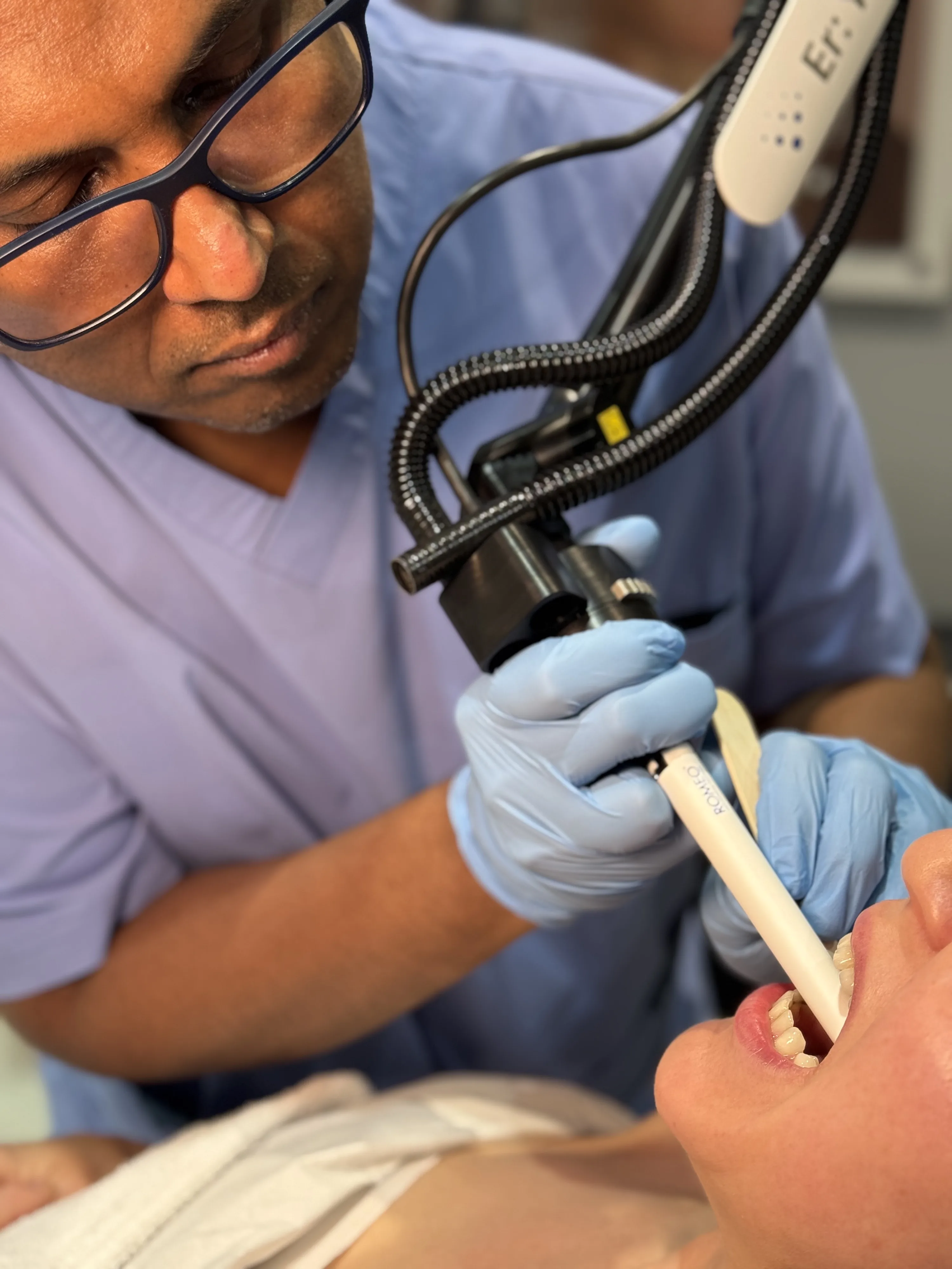 Doctor-led Romeo Anti-Snoring Laser treatment at Rejuvena Clinic in Bedford, clinician using a laser handpiece near the mouth