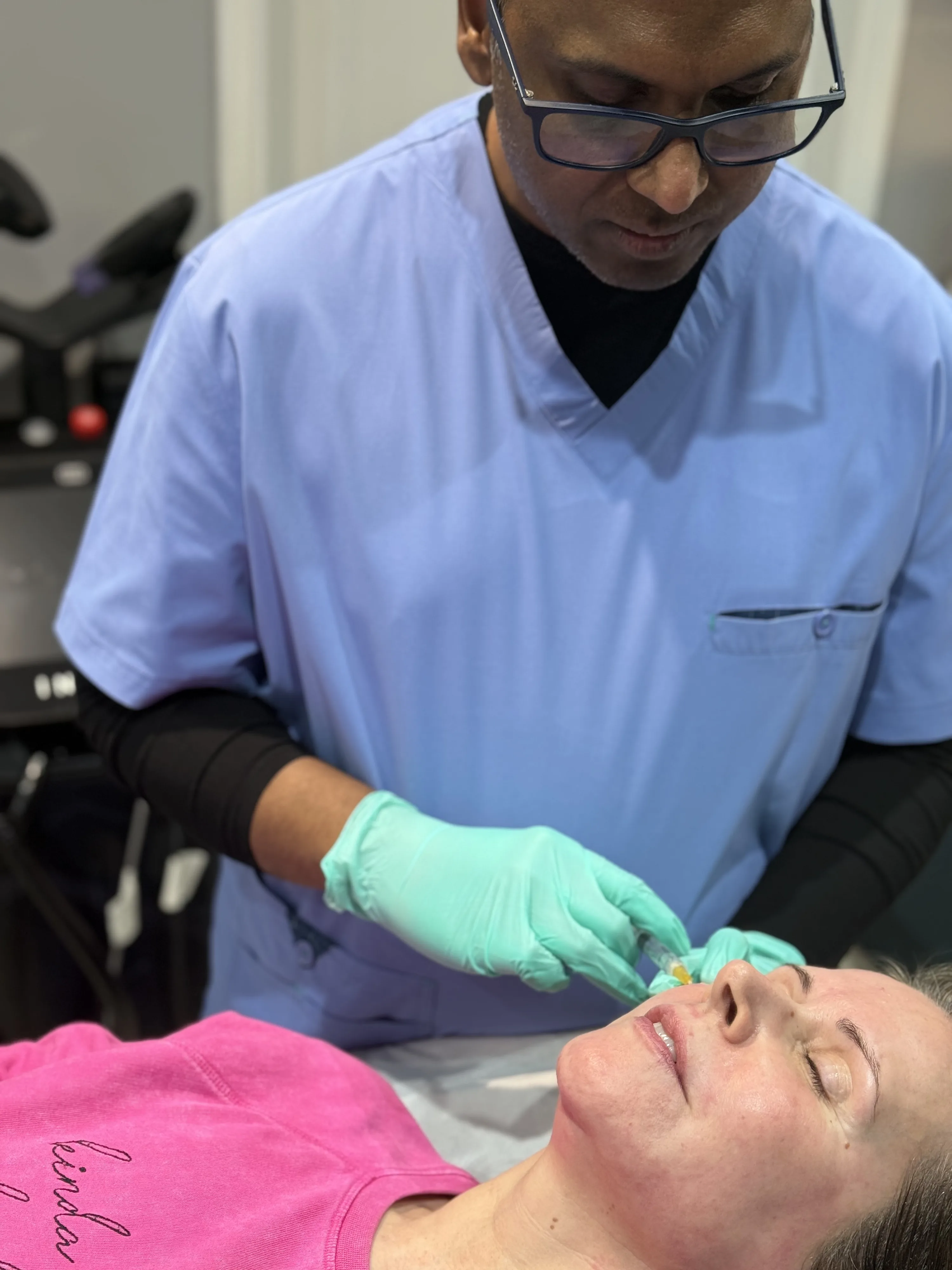 Dr Nick assessing a patient for Sculptra collagen-stimulating injections at Rejuvena Clinic in Bedford