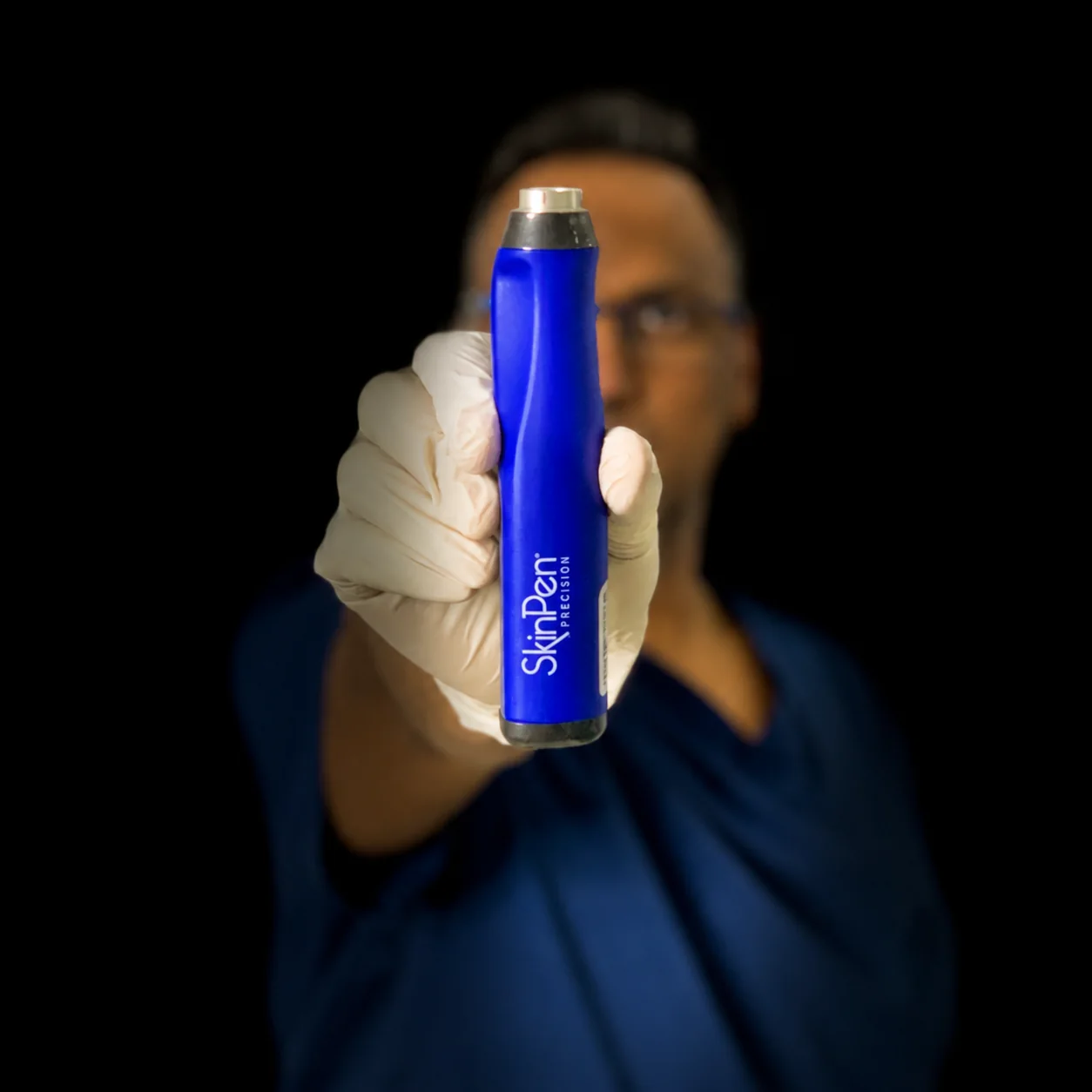 Dr Nick holding the SkinPen Precision microneedling device at Rejuvena Clinic, Bedford