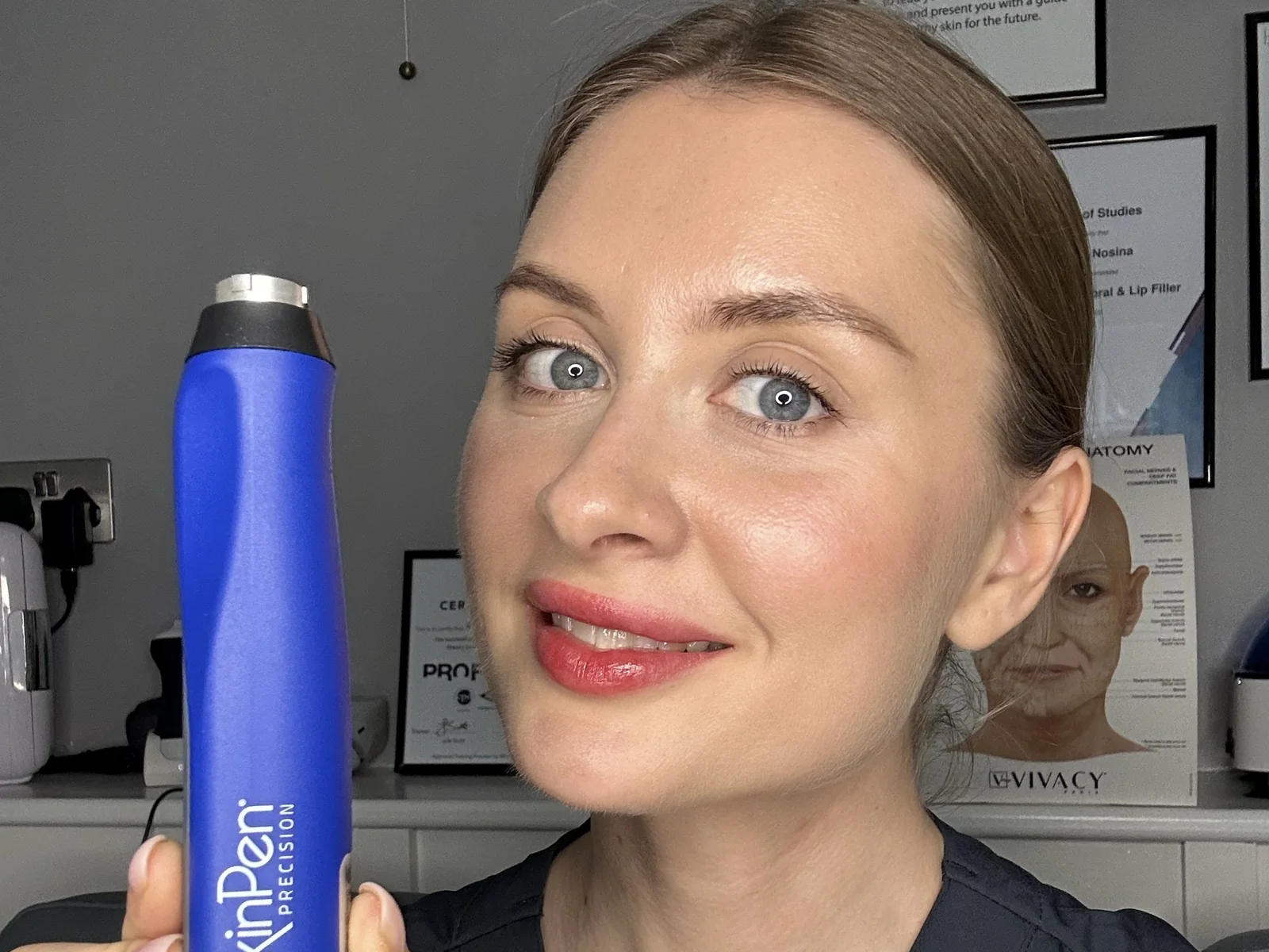 Rejuvena team member holding the SkinPen Precision microneedling device in our Bedford clinic