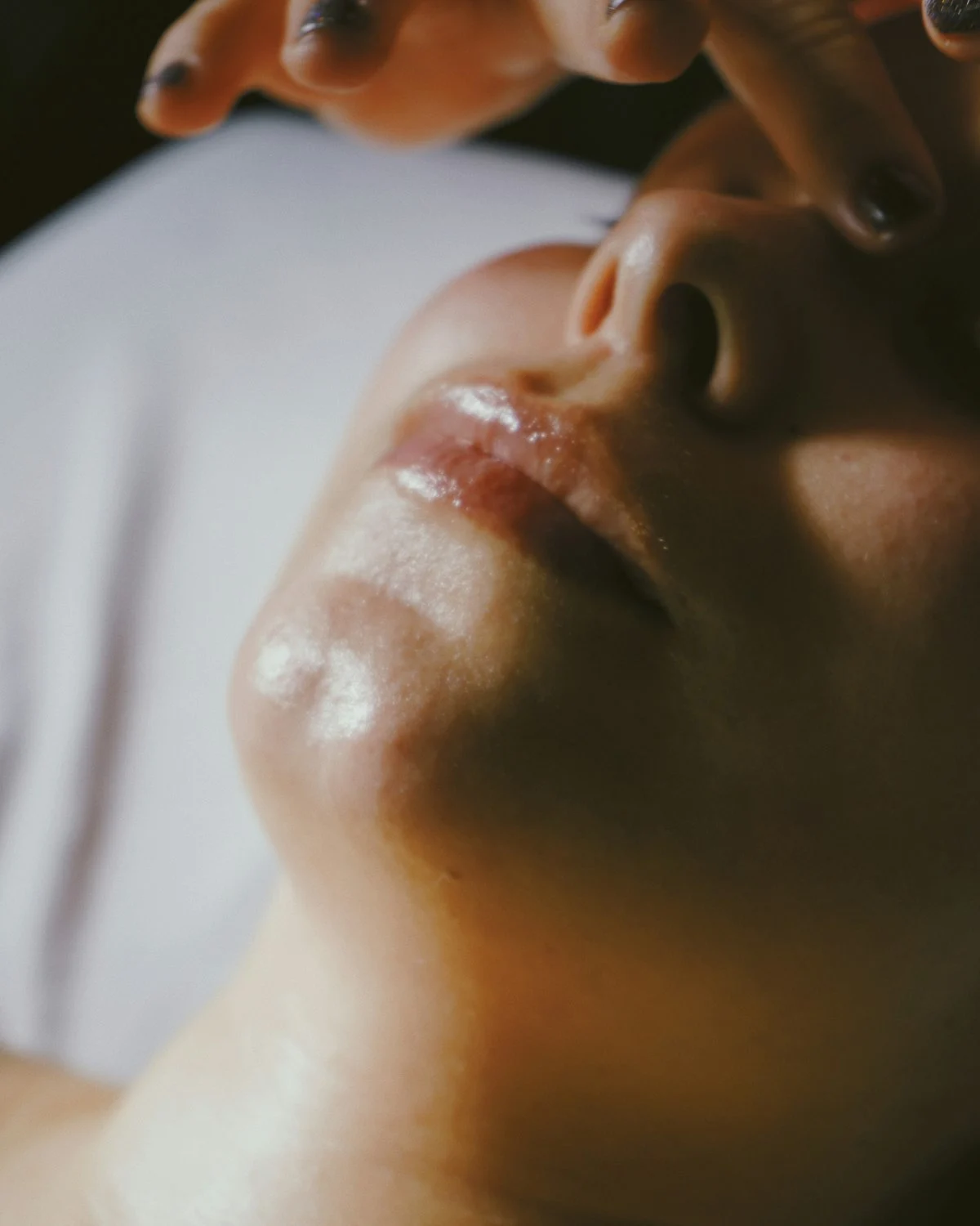 Close-up of gentle hands-on touch on smooth, glowing skin — illustrative of the PRX-T33 no-needle peel at Rejuvena Bedford