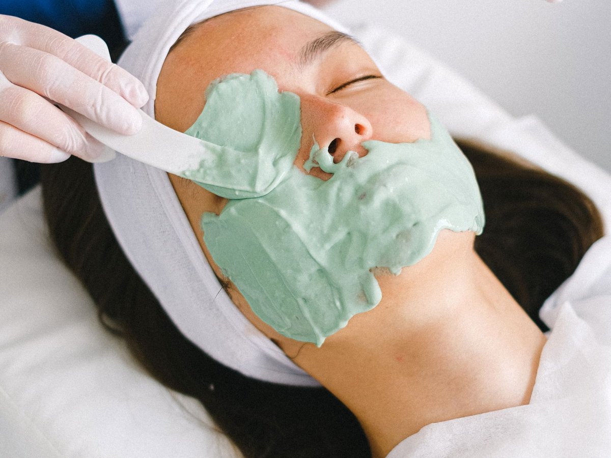 Depigmenting peel mask being applied to the cheek during doctor-led treatment for uneven skin tone, Rejuvena Bedford