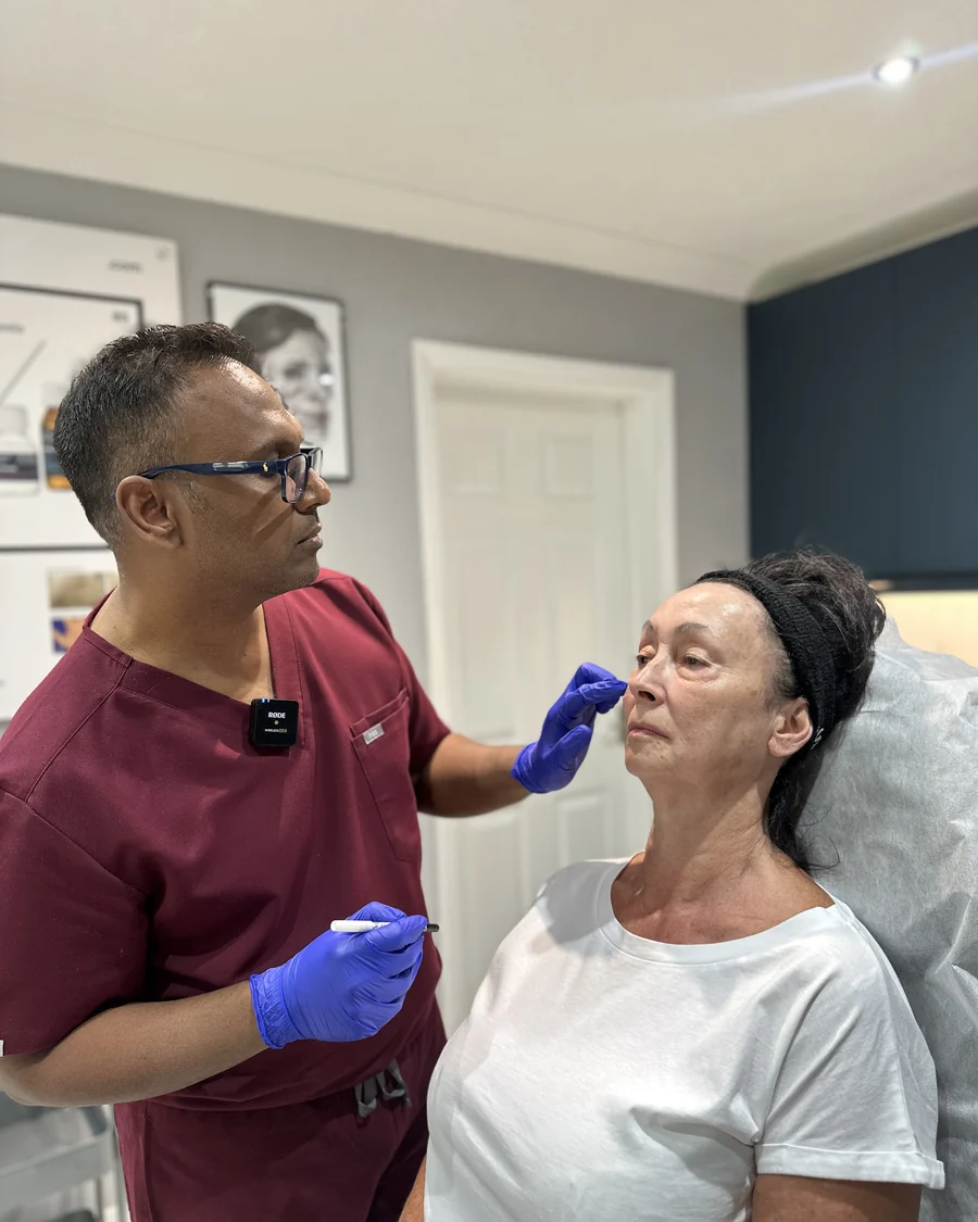 Dr Nick assessing and marking a patient's face before anti-wrinkle injections at our Bedford clinic