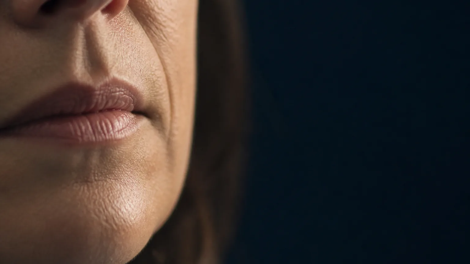 Adult lower face showing defined nasolabial folds beside the mouth