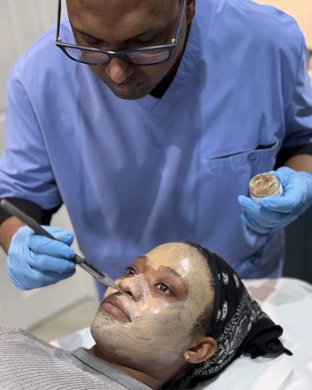 Dr Nick applying the Cosmelan&reg; depigmentation mask to a patient’s face at Rejuvena Clinic, Bedford