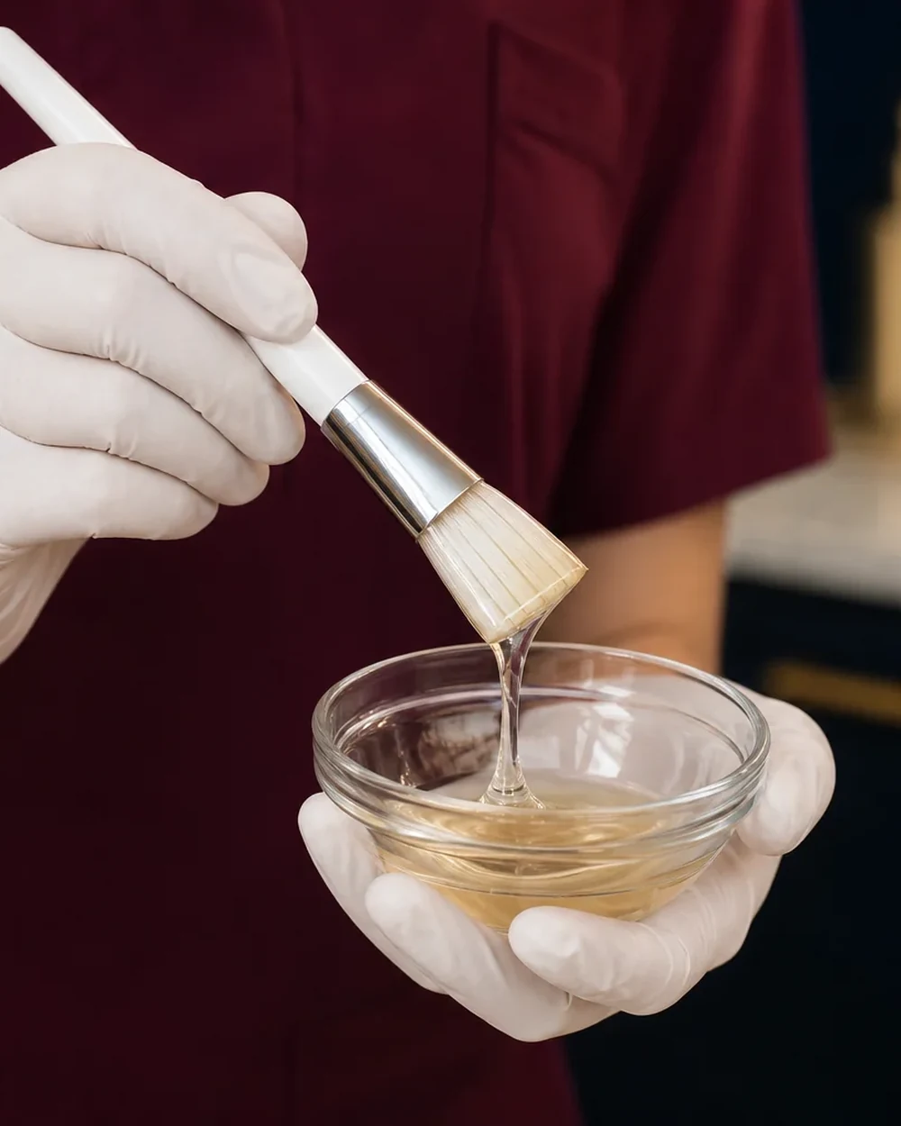 A gloved clinician preparing a professional brightening peel at Rejuvena Clinic, Bedford