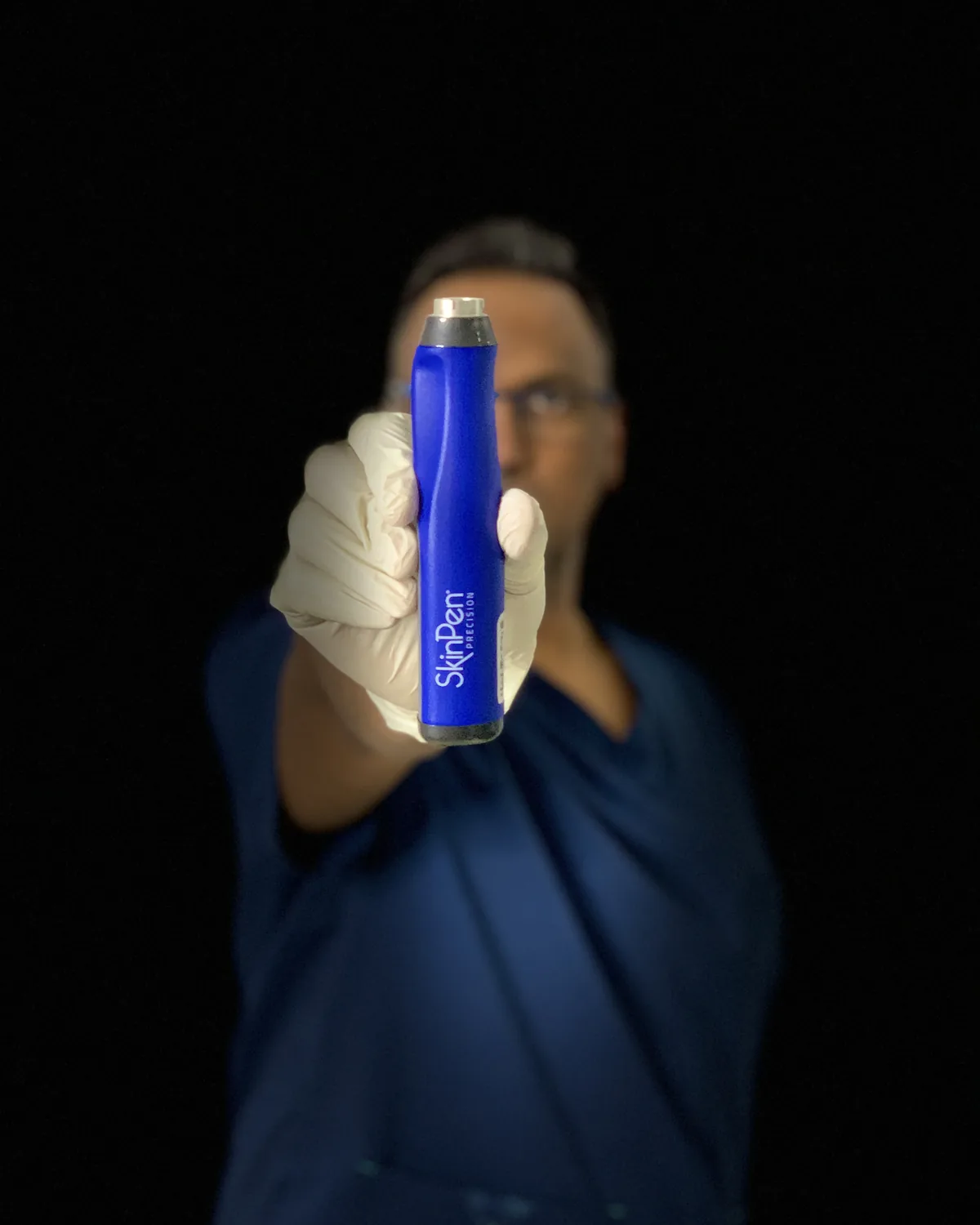 Dr Nick holding the medical-grade SkinPen Precision microneedling device at Rejuvena Clinic, Bedford