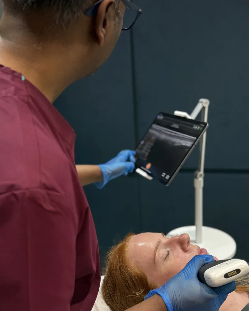 Dr Nick assessing a patient's under-eye area during a doctor-led dark circle consultation at Rejuvena Clinic, Bedford