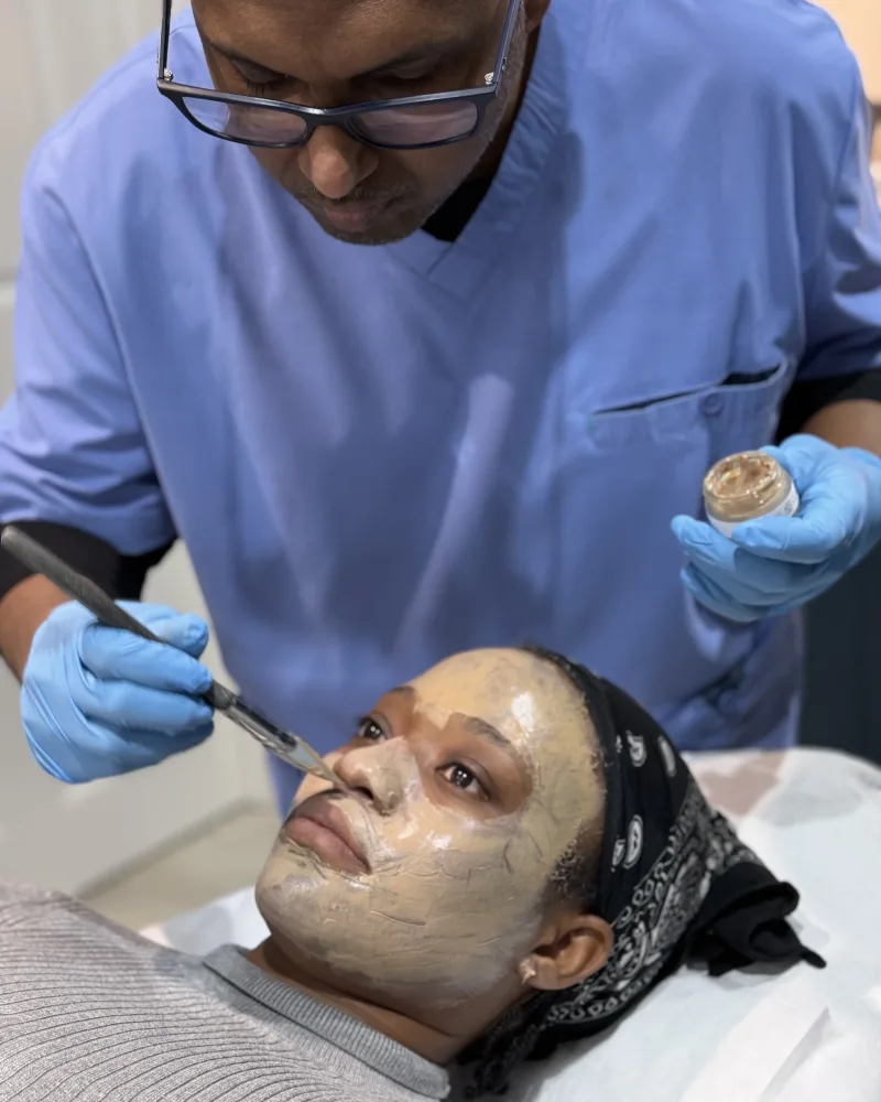 Dr Nick assessing symmetrical facial melasma under a light-based skin analysis during doctor-led care at Rejuvena Clinic, Bedford