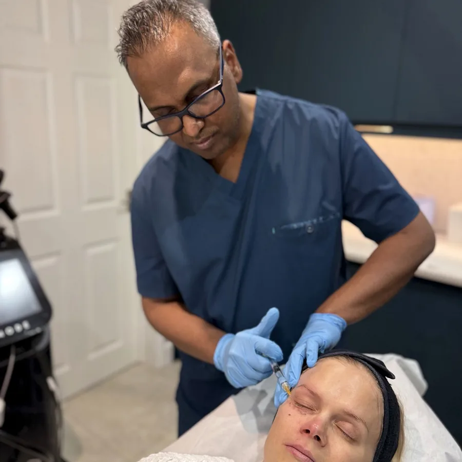 Dr Nick carrying out an under-eye injectable treatment on a patient at Rejuvena Clinic in Bedford