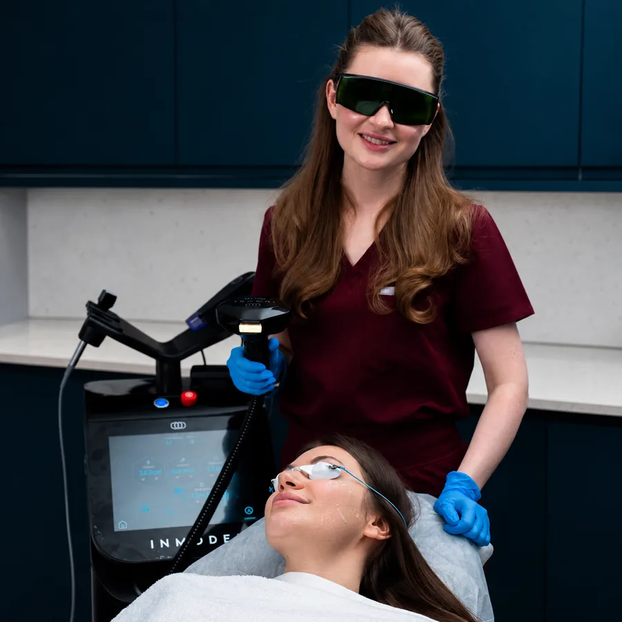 Lana with the InMode Lumecca IPL handpiece beside a patient wearing protective eyewear at Rejuvena Clinic, Bedford