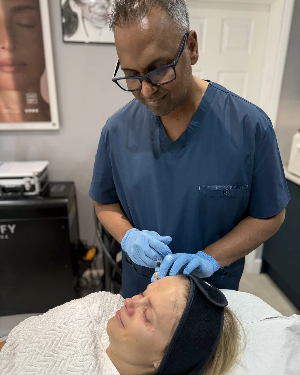 Dr Nick performing a polynucleotide skin-booster treatment on a patient in our Bedford clinic