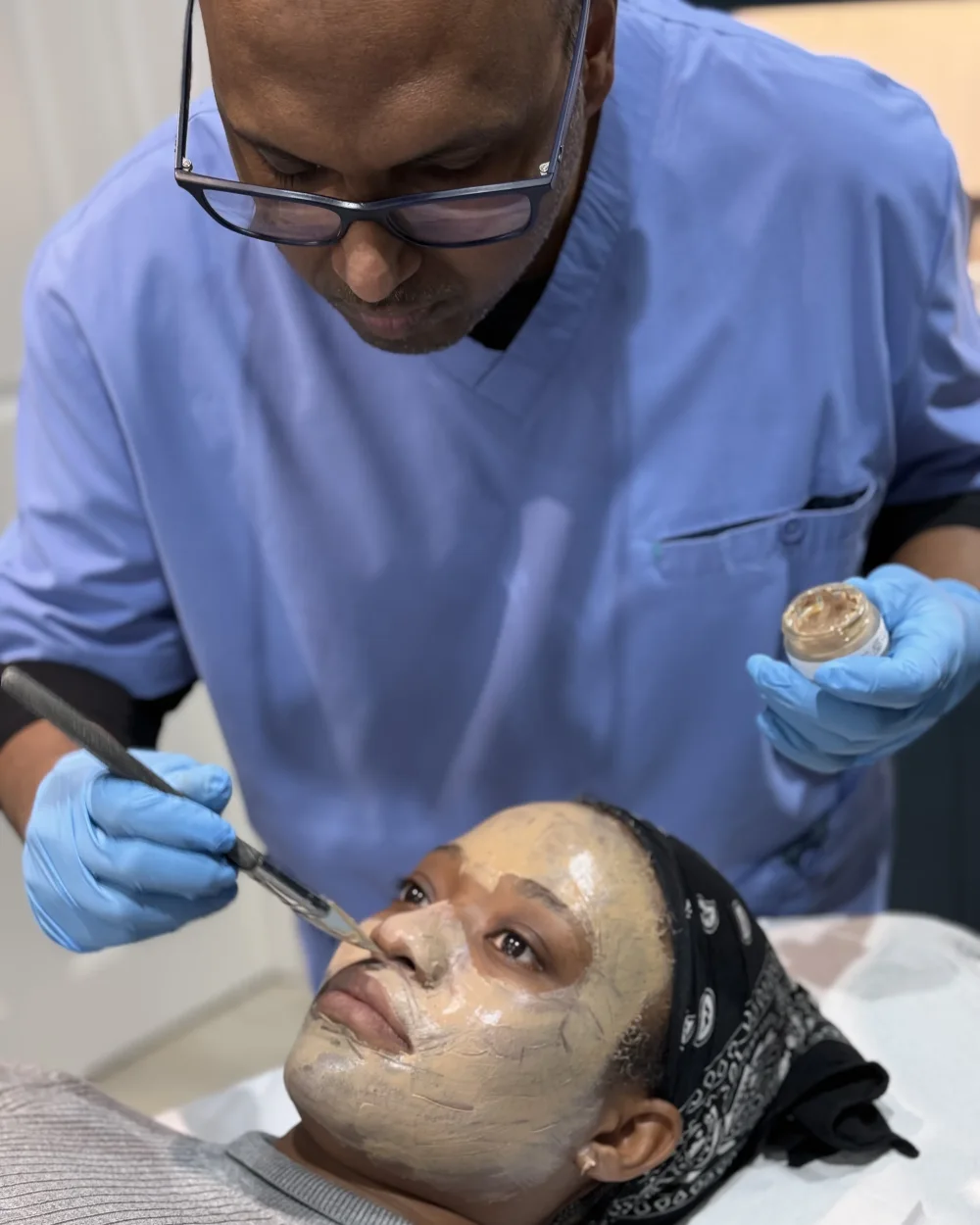 Dr Nick applying a professional depigmentation treatment to a patient's face at Rejuvena Clinic in Bedford