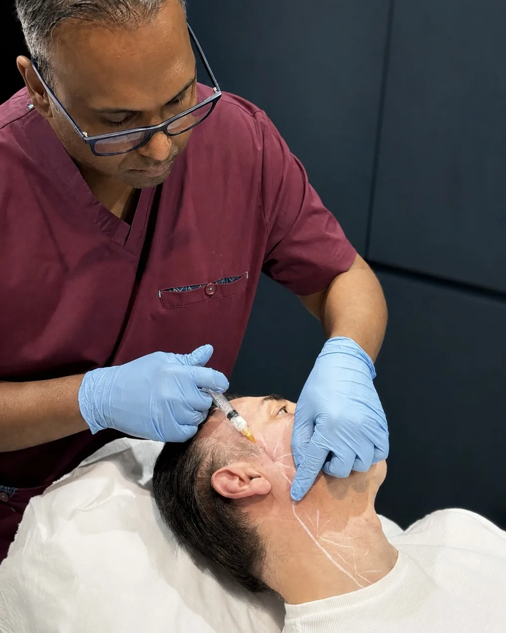Dr Nick performing a Radiesse chin and jawline injection at Rejuvena Clinic in Bedford